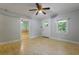 Bright living room with hardwood floors, ceiling fan, and natural light from a window and open doorway at 2234 River Rd, Johns Island, SC 29455