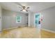 Inviting living area with a light floor, ceiling fan, and an open design leading to other rooms at 2234 River Rd, Johns Island, SC 29455