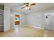 Large living room with wood floors, ceiling fan, and an open doorway to the kitchen at 2234 River Rd, Johns Island, SC 29455