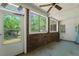 Enclosed porch with brick accents, lots of windows, and access to backyard at 2234 River Rd, Johns Island, SC 29455