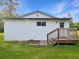 A side view of the house including the back yard, back door, and access stairs at 224 Reeves St, Reevesville, SC 29471
