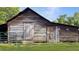 Picture of weathered barn with fenced in area, and two access doors at 224 Reeves St, Reevesville, SC 29471