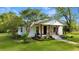 Charming single-story home with a covered front porch and well-manicured lawn at 224 Reeves St, Reevesville, SC 29471