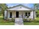 Inviting front porch with chairs, plants, and charming details at 224 Reeves St, Reevesville, SC 29471