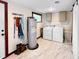 Laundry room with a utility sink, washer, dryer, and barn door access to the house at 224 Reeves St, Reevesville, SC 29471