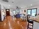 Cozy open concept living room and dining area with hardwood flooring at 224 Reeves St, Reevesville, SC 29471
