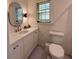 Well-lit bathroom with a vanity, oval mirror, and a toilet, all in a clean, contemporary design at 2331 Furman Dr, Charleston, SC 29414