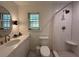 Bright bathroom featuring a walk-in shower, white tiling, and sleek fixtures at 2331 Furman Dr, Charleston, SC 29414