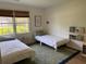 Cozy bedroom featuring two twin beds with soft, neutral bedding, and natural light from the windows at 2331 Furman Dr, Charleston, SC 29414