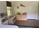 Well-lit bedroom with hardwood floors, features wooden shelving and a window view at 2331 Furman Dr, Charleston, SC 29414