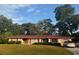 Charming single-story home featuring a brick facade, red roof, and a well-manicured lawn at 2331 Furman Dr, Charleston, SC 29414