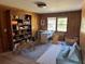 Spacious living room featuring a built-in bookcase, a large window, and modern furniture at 2331 Furman Dr, Charleston, SC 29414