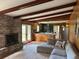 Comfortable living area featuring a sectional sofa, exposed beams, and a brick fireplace at 2331 Furman Dr, Charleston, SC 29414
