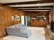 Open living room featuring wood paneling, built-in bookshelves and a brick fireplace at 2331 Furman Dr, Charleston, SC 29414