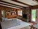 Open living room with natural light featuring wood paneling, built-in bookshelves and a fireplace at 2331 Furman Dr, Charleston, SC 29414