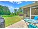 Spacious backyard with a screened porch, lush green grass, and mature trees offering privacy at 236 Everwood Ct, Moncks Corner, SC 29461