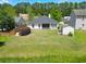 Aerial image of a home featuring a well-maintained backyard with a lawn and shed near the woods at 236 Everwood Ct, Moncks Corner, SC 29461