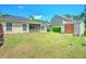Expansive backyard featuring a screened porch, storage shed, and well-maintained lawn at 236 Everwood Ct, Moncks Corner, SC 29461