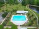Overhead shot of community pool area with chairs, umbrellas, and other outdoor amenities surrounded by lawn at 236 Everwood Ct, Moncks Corner, SC 29461