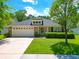 Charming home showcasing a manicured lawn, brick accents, and an inviting two-car garage at 236 Everwood Ct, Moncks Corner, SC 29461