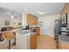 A kitchen showcasing wooden cabinets, a breakfast bar, and an open layout leading to the living area at 236 Everwood Ct, Moncks Corner, SC 29461
