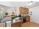 Bright kitchen featuring a breakfast bar, light wood cabinets, and modern appliances in an open-concept design at 236 Everwood Ct, Moncks Corner, SC 29461