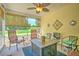 Relaxing screened porch featuring comfortable seating and a ceiling fan for enjoying the outdoors at 236 Everwood Ct, Moncks Corner, SC 29461