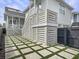 Backyard with stairs to a porch and a geometric stone and grass grid, enhanced by a dark privacy fence at 2524 Josiah St, Charleston, SC 29492