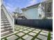Backyard featuring a staircase, a dark fence, and a decorative stone and grass grid pattern at 2524 Josiah St, Charleston, SC 29492