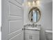 Cozy bathroom featuring a vanity with granite countertop, a round mirror and a toilet at 2524 Josiah St, Charleston, SC 29492