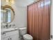 Elegant bathroom featuring a granite vanity, modern fixtures, and a round mirror at 2524 Josiah St, Charleston, SC 29492