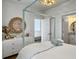 Light-filled bedroom boasting a four-poster bed, bright white dresser, and modern lighting at 2524 Josiah St, Charleston, SC 29492