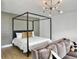 Comfortable bedroom space with a four-poster bed, soft lighting, and contemporary furniture at 2524 Josiah St, Charleston, SC 29492