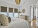 Bedroom with modern decor, tray ceiling, and three windows bringing in natural light at 2524 Josiah St, Charleston, SC 29492