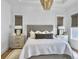 Bedroom features a plush bed, modern lighting, and natural light through the windows at 2524 Josiah St, Charleston, SC 29492