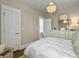 Relaxing bedroom featuring a neutral color palette, modern white dresser, and chandelier at 2524 Josiah St, Charleston, SC 29492