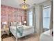 Stylish bedroom with a four-poster bed, eye-catching wallpaper, and modern lighting fixture at 2524 Josiah St, Charleston, SC 29492