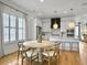 Dining area with wood floors, round table, and bright natural light through large windows at 2524 Josiah St, Charleston, SC 29492