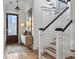Inviting foyer with hardwood floors, a staircase with black handrail, and a stylish console table at 2524 Josiah St, Charleston, SC 29492