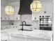 Modern kitchen with white cabinets, stainless steel appliances, and marble backsplash at 2524 Josiah St, Charleston, SC 29492