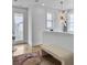 Upstairs landing showcasing hardwood floors, a bench, and stylish light fixture and windows at 2524 Josiah St, Charleston, SC 29492