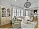 Living room with plush seating, decorative rug, and view into the modern kitchen at 2524 Josiah St, Charleston, SC 29492