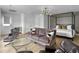 Well-lit living area showcasing a plush sofa, stylish lounge chairs, and a decorative light fixture at 2524 Josiah St, Charleston, SC 29492