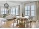 Bright living area with large windows, a round table, and comfortable seating with decorative pillows at 2524 Josiah St, Charleston, SC 29492