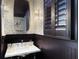 Stylish powder room featuring dark wainscoting and patterned wallpaper at 2524 Josiah St, Charleston, SC 29492