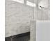 Modern bathroom featuring gray marbled tiling, a shower head, and a sleek glass enclosure at 2524 Josiah St, Charleston, SC 29492