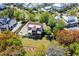 Beautiful aerial view of a waterfront home with a screened porch, outdoor fire pit and lush landscaping at 2538 Helmsman Rd, Johns Island, SC 29455