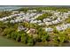 Beautiful aerial view of a charming neighborhood with waterfront homes surrounded by lush greenery and a lake at 2538 Helmsman Rd, Johns Island, SC 29455