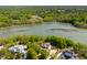 Picturesque aerial view of a waterfront home surrounded by lush greenery and a serene river at 2538 Helmsman Rd, Johns Island, SC 29455