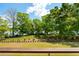 Beautiful backyard featuring green grass, mature trees and a view of the water at 2538 Helmsman Rd, Johns Island, SC 29455